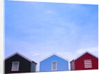 Beach huts in a row against sky by Assaf Frank